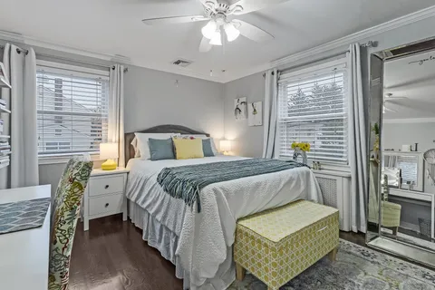 a spacious bedroom with a bed and a chandelier