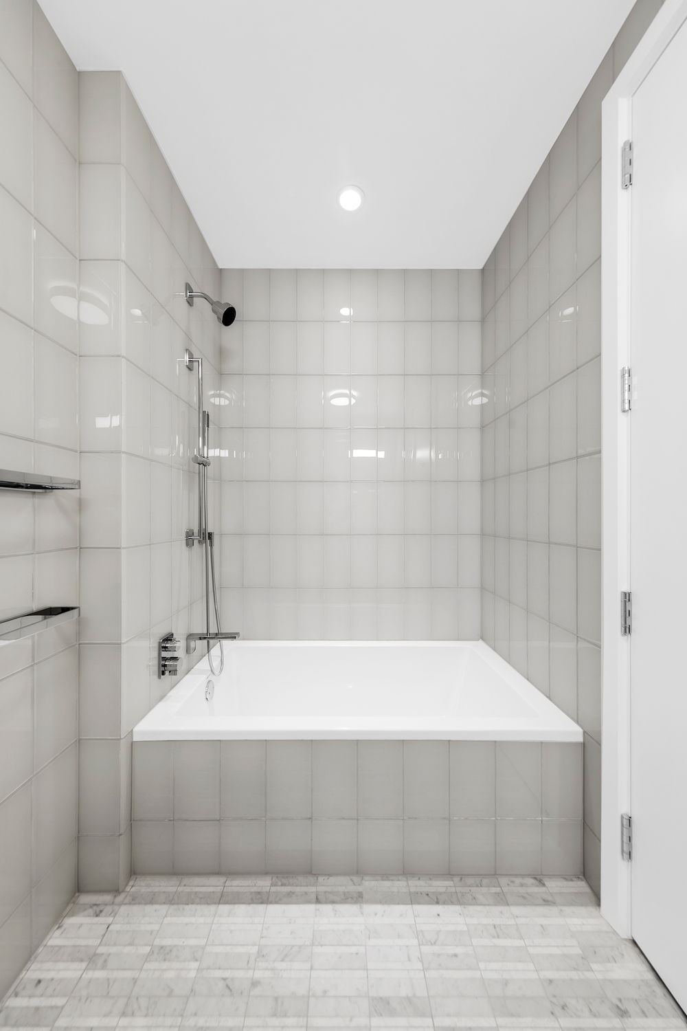 50 West 66th Street, Unit 17A Manhattan, NY 10023 - Photo 16 of 49 a bathroom with a bathtub and shower