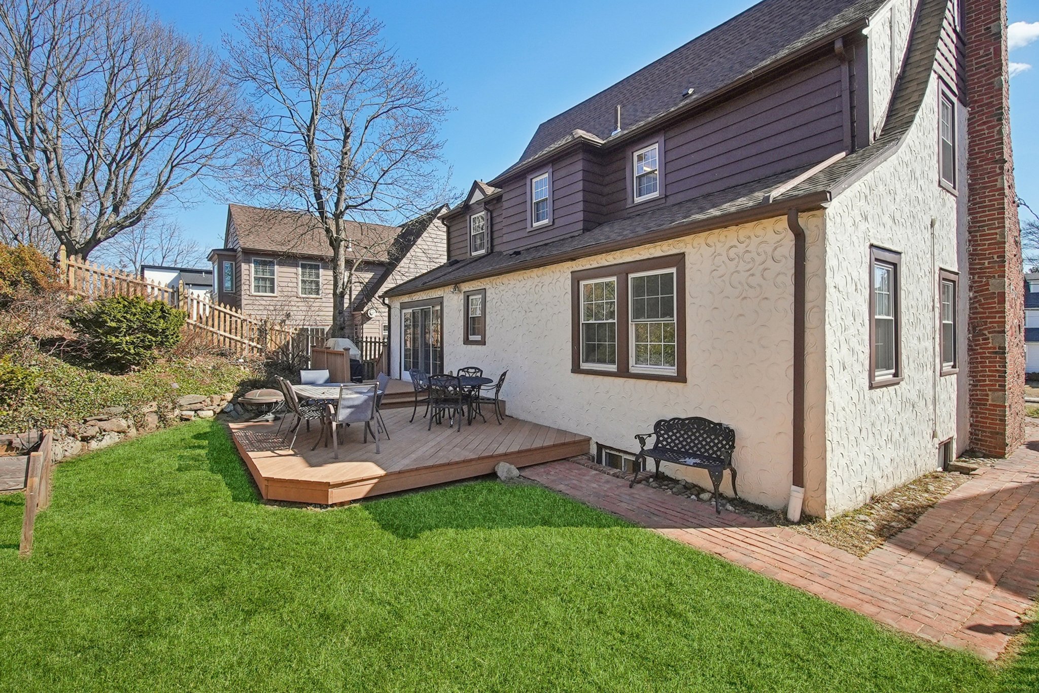 877 Ridgewood Road Millburn, NJ 07041 - Photo 30 of 37 a view of backyard of house with outdoor seating and barbeque oven