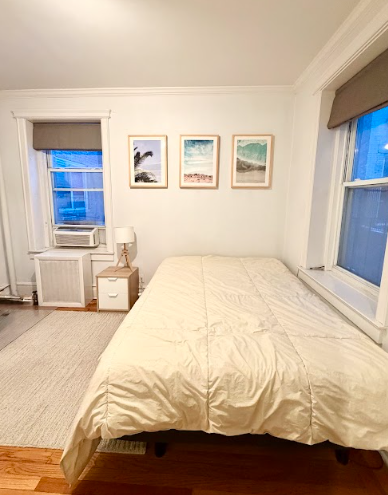 223 East 50th Street, Unit 1C Manhattan, NY 10022 - Photo 7 of 10 a bedroom with a bed and a couch