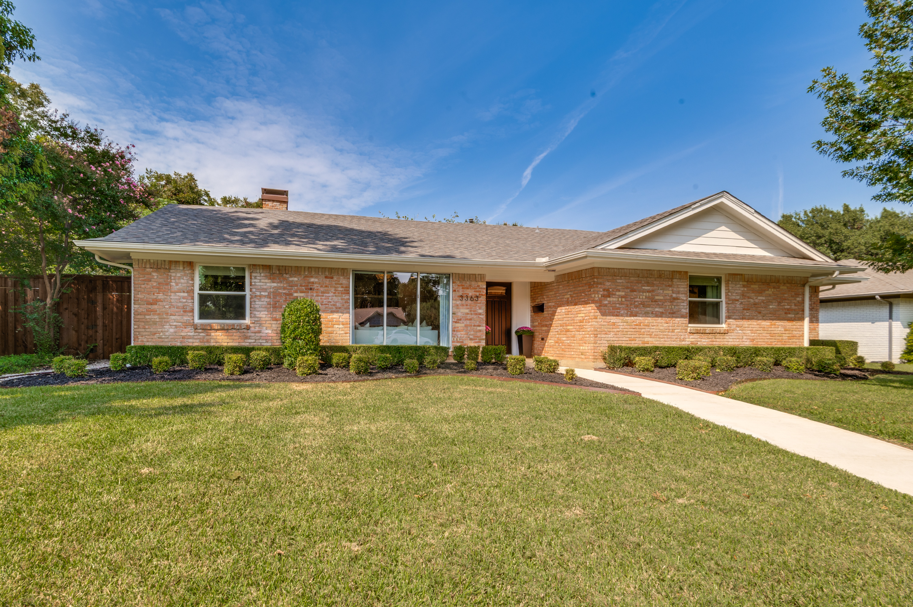 a front view of a house with a garden