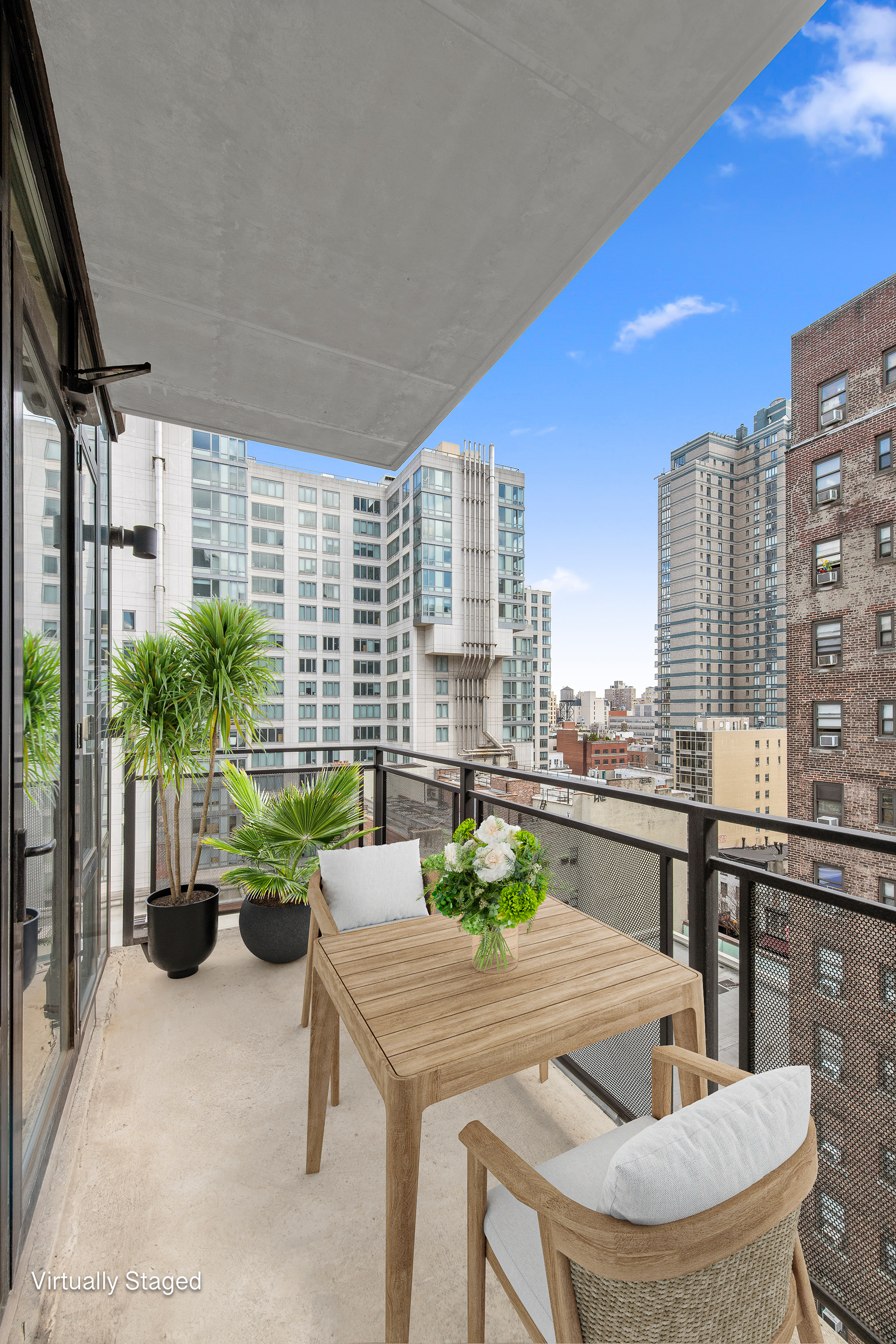 148 East 24th Street, Unit 12B Manhattan, NY 10010 - Photo 5 of 13 a dining room with couches chairs and a potted plant