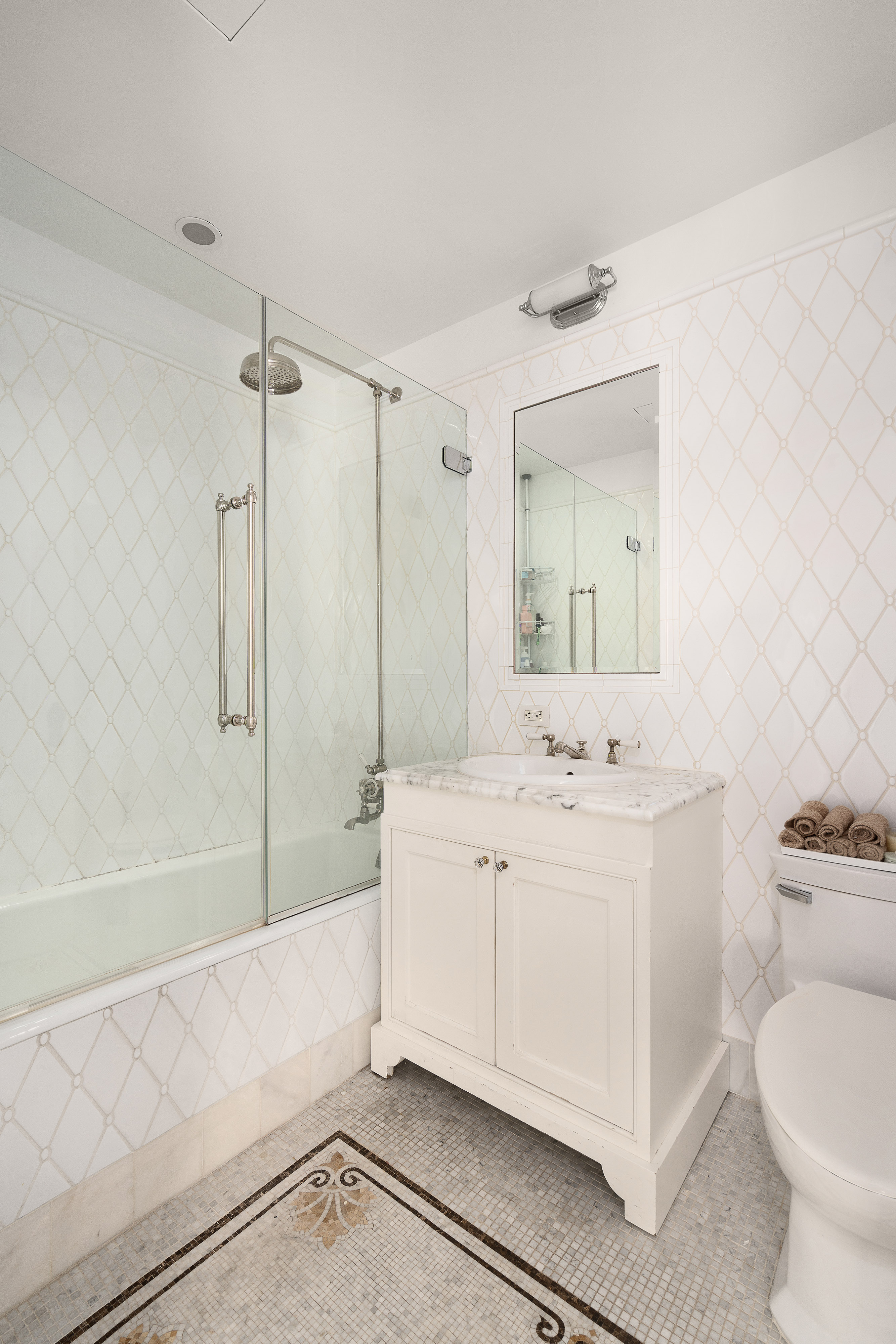 1 Central Park South, Unit 1804 Manhattan, NY 10019 - Photo 9 of 23 a spacious bathroom with a bathtub shower sink mirror and toilet