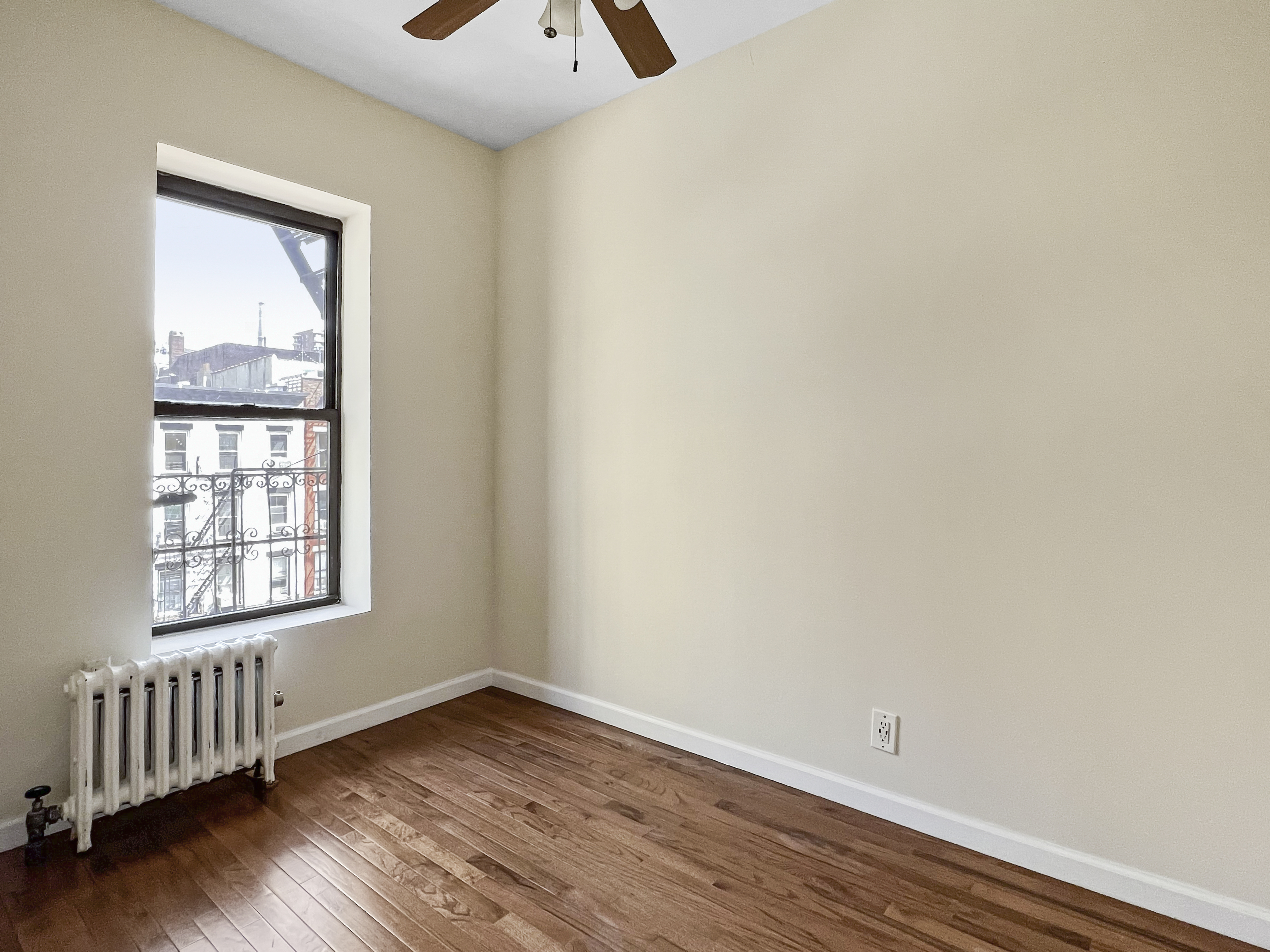 270 East 78th Street, Unit 13 Manhattan, NY 10075 - Photo 3 of 3 an empty room with wooden floor and windows