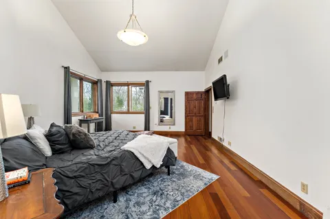 a spacious bedroom with a bed and large window