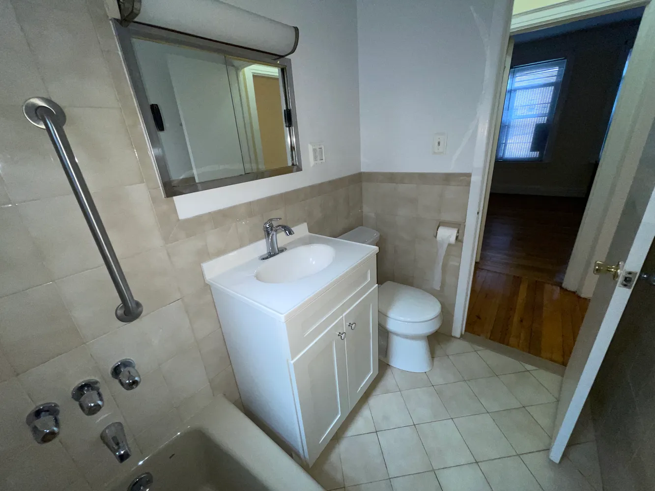 a bathroom with a sink a toilet and a mirror