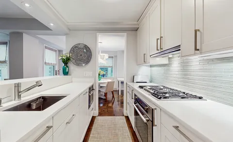 a kitchen with a sink stove and cabinets