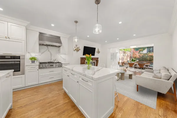 a kitchen with white cabinets and stainless steel appliances