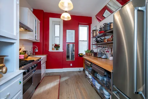 a kitchen with stainless steel appliances granite countertop a refrigerator and a stove top oven