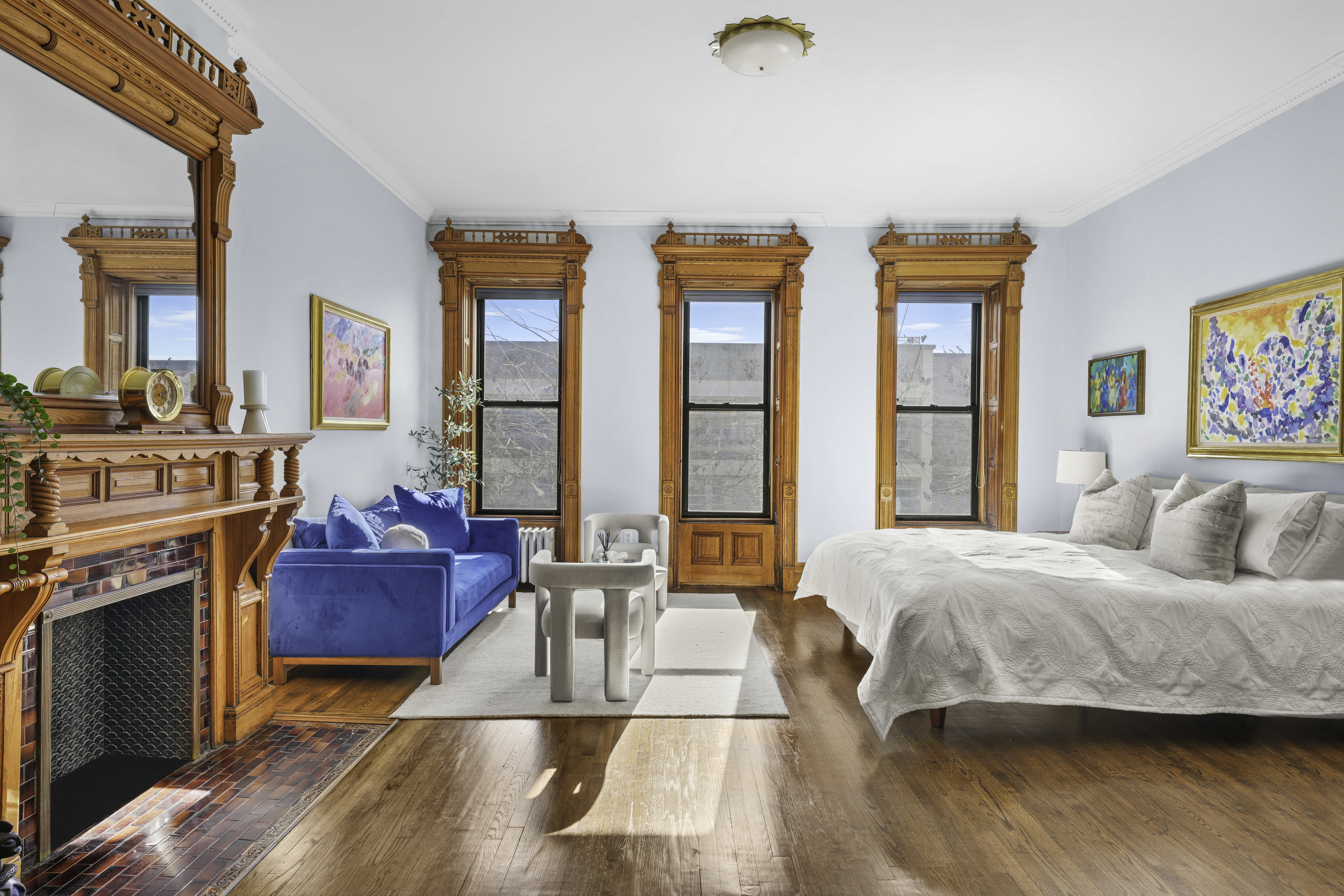 127 West 122nd Street Manhattan, NY 10027 - Photo 11 of 17 a bedroom with a bed and large windows