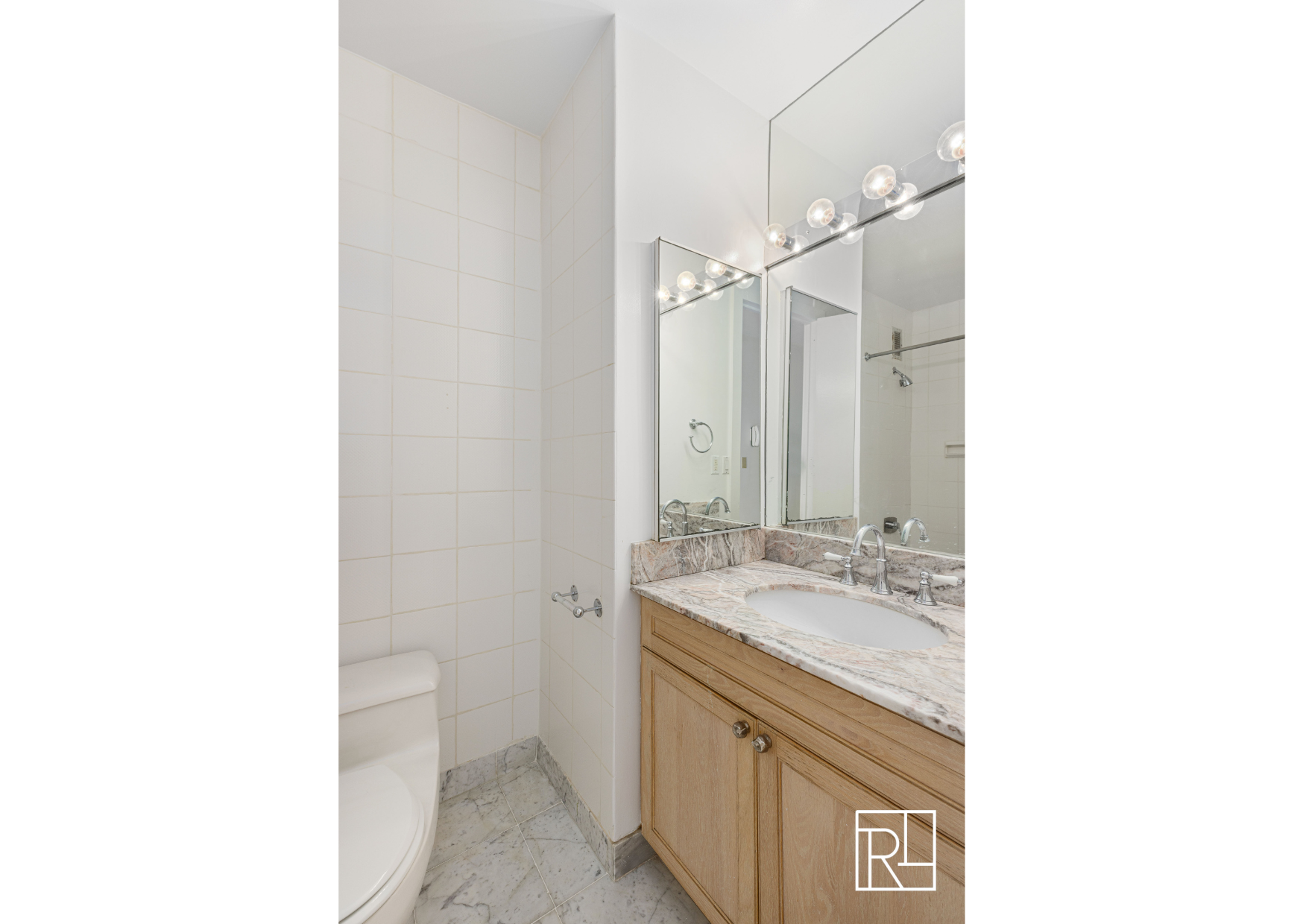 30 West 61st Street, Unit 16D Manhattan, NY 10023 - Photo 11 of 12 a bathroom with a sink a toilet and shower