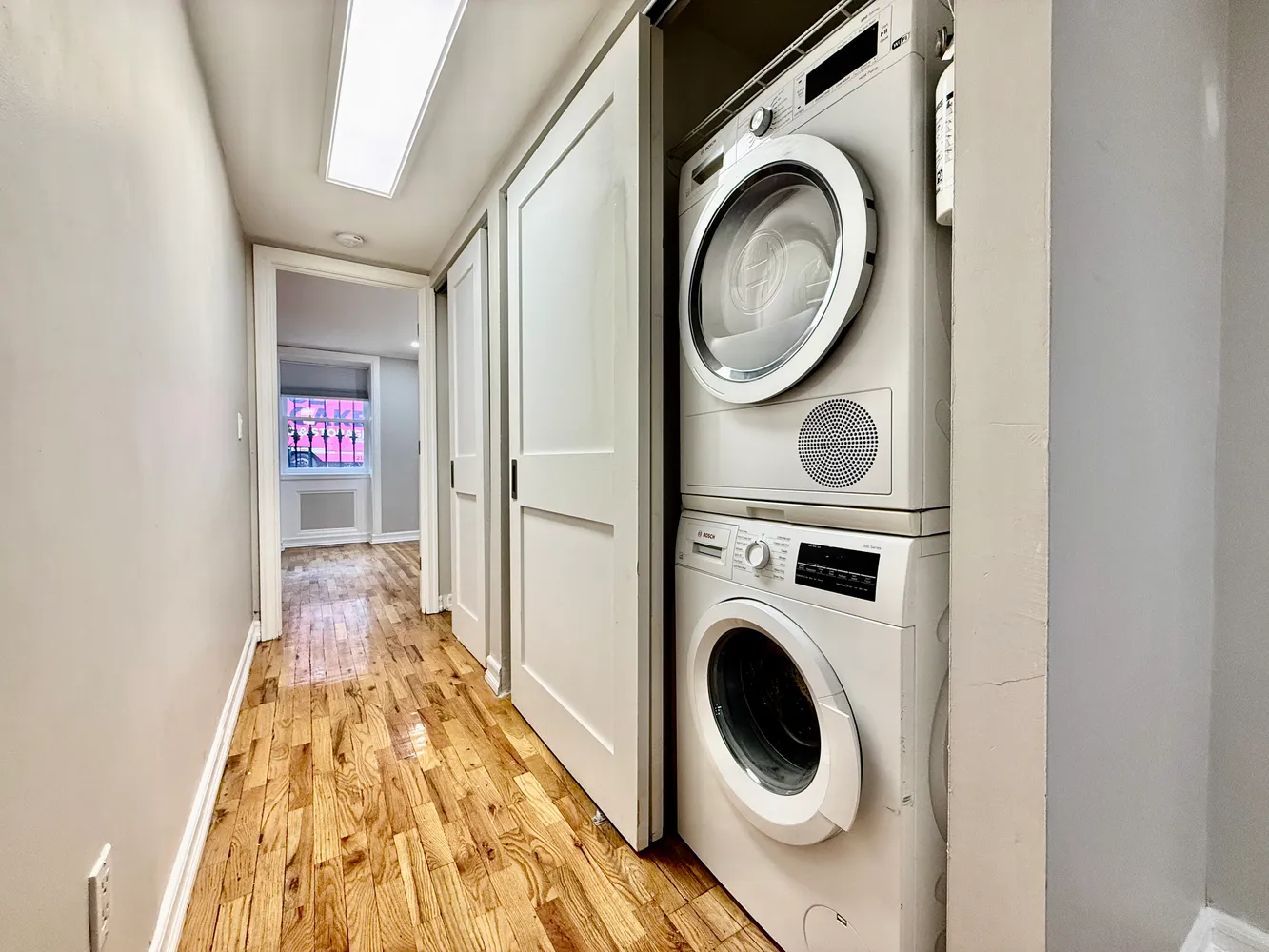 a view of a hallway with washer and dryer