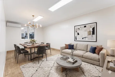 a living room with furniture a rug and a chandelier