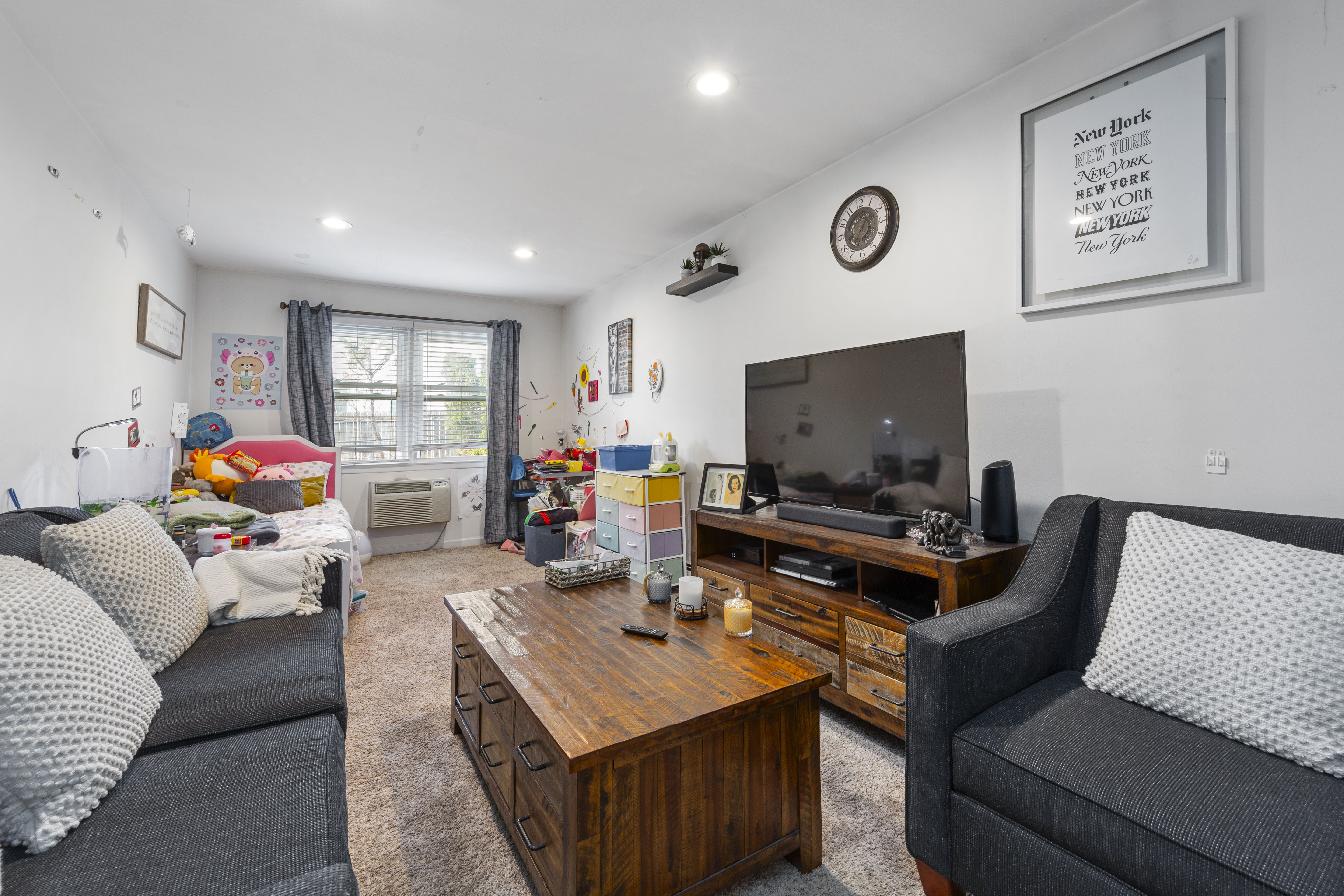 240-47 68th Avenue Queens, NY 11362 - Photo 4 of 39 a living room with furniture and a flat screen tv