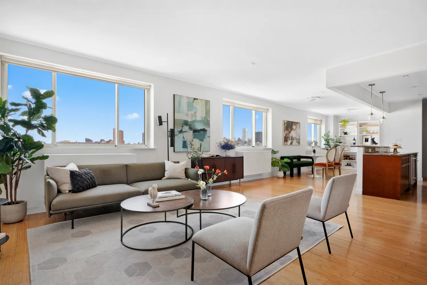 a living room with furniture and a dining table with wooden floor