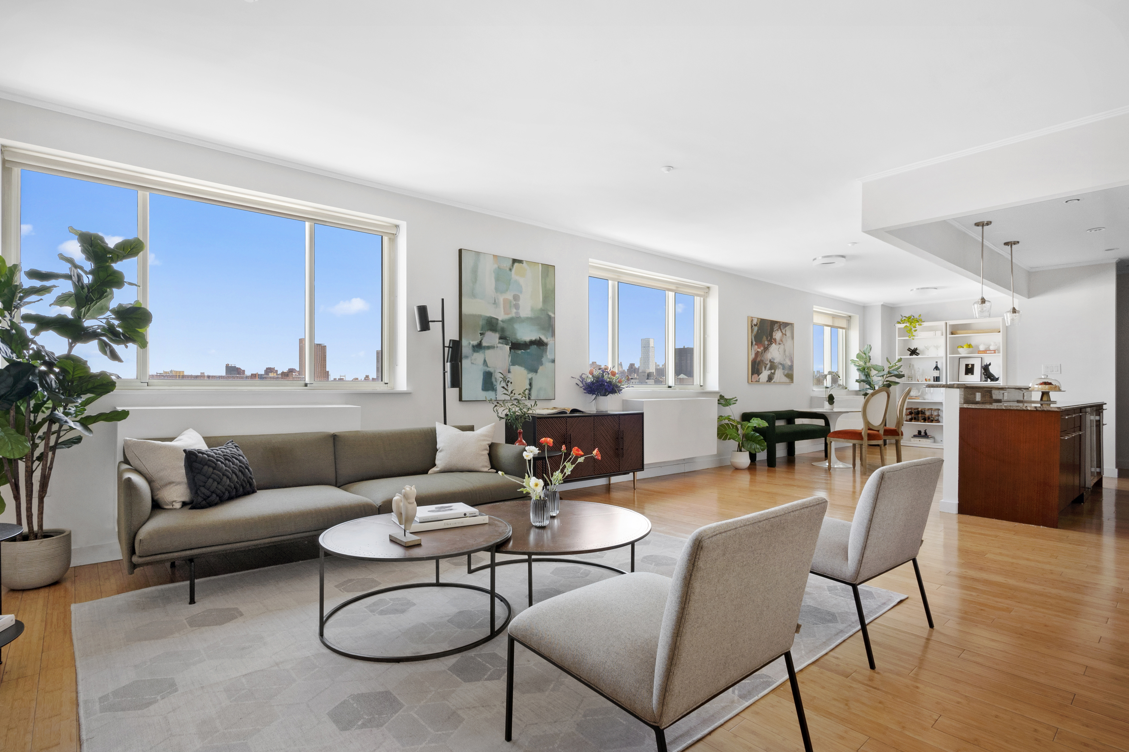 301 West 115th Street, Unit PH4C Manhattan, NY 10026 - Photo 1 of 15 a living room with furniture and a dining table with wooden floor