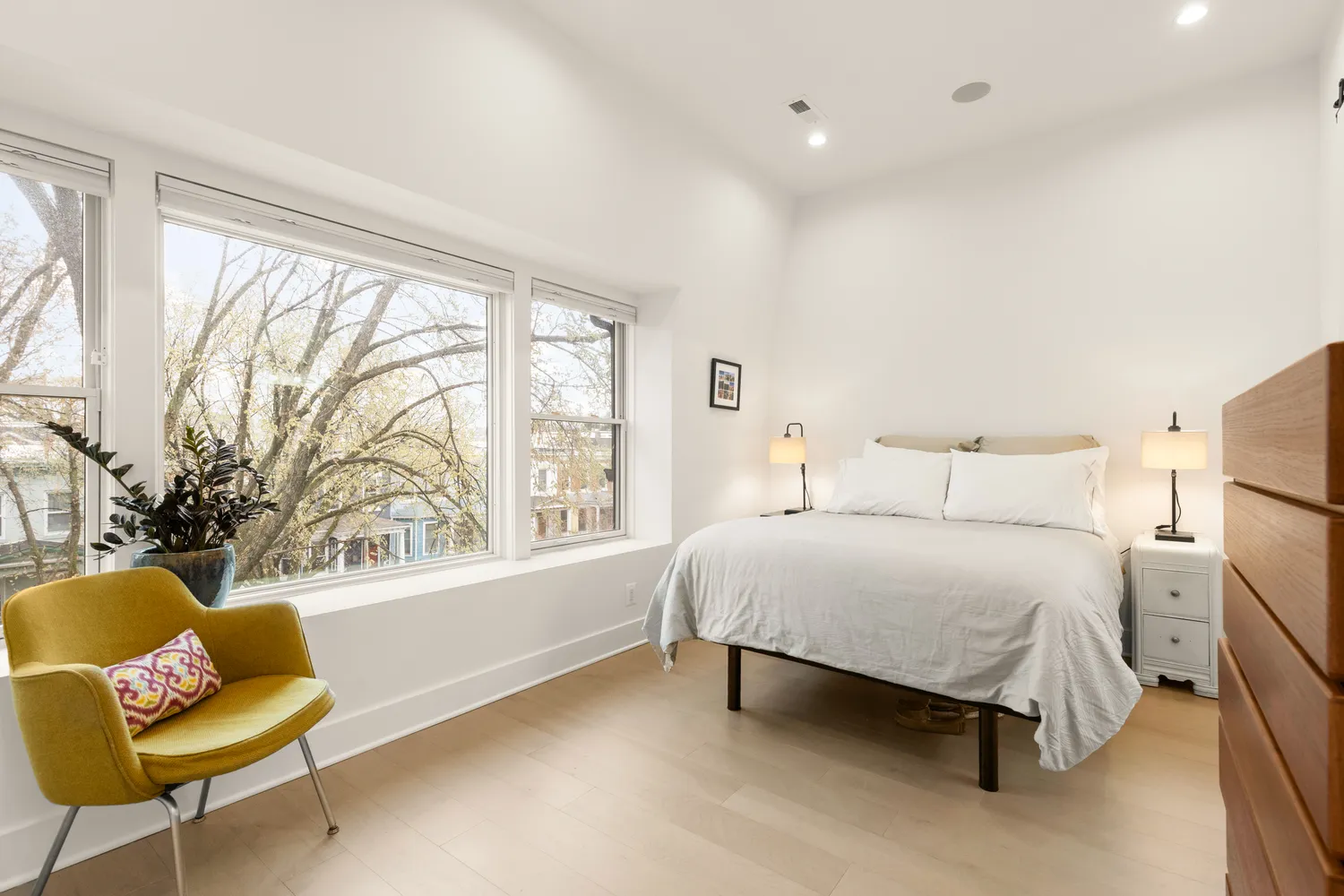 a spacious bedroom with a bed and a couch