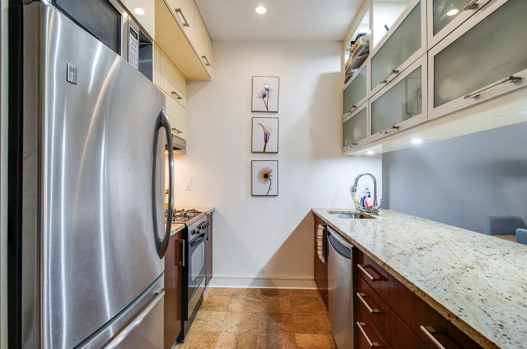 41-26 27th Street, Unit 4B Queens, NY 11101 - Photo 3 of 10 a kitchen with stainless steel appliances granite countertop a refrigerator and a sink