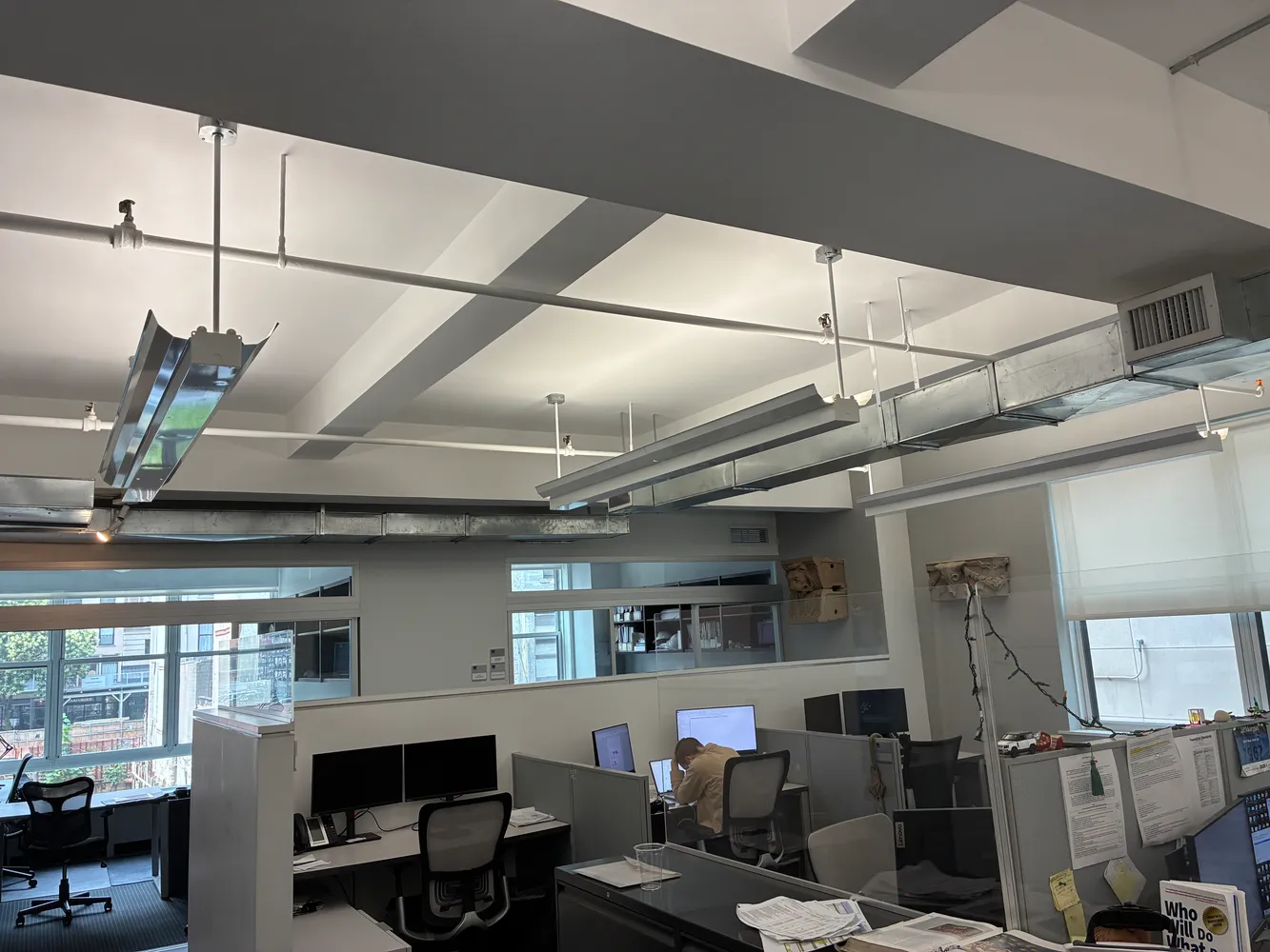 a view of a workspace with furniture and a window