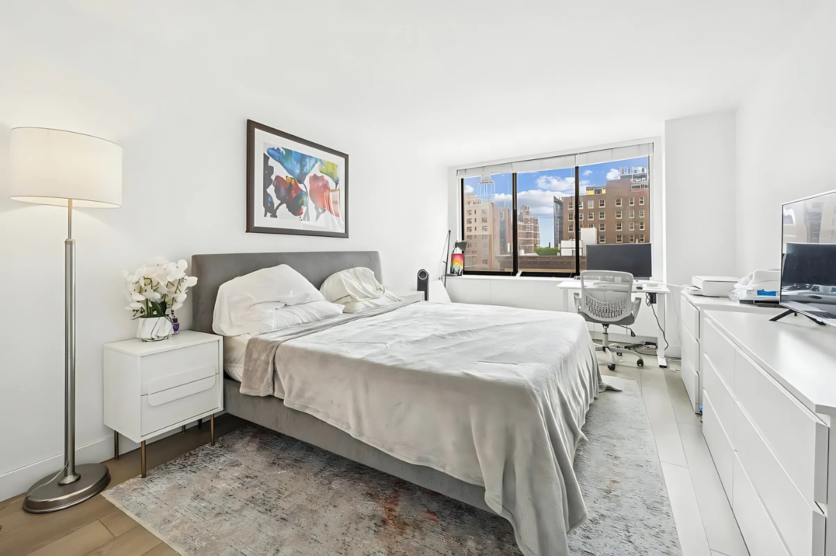 215 West 95th Street, Unit 9J Manhattan, NY 10025 - Photo 4 of 11 a room with a bed and a large window