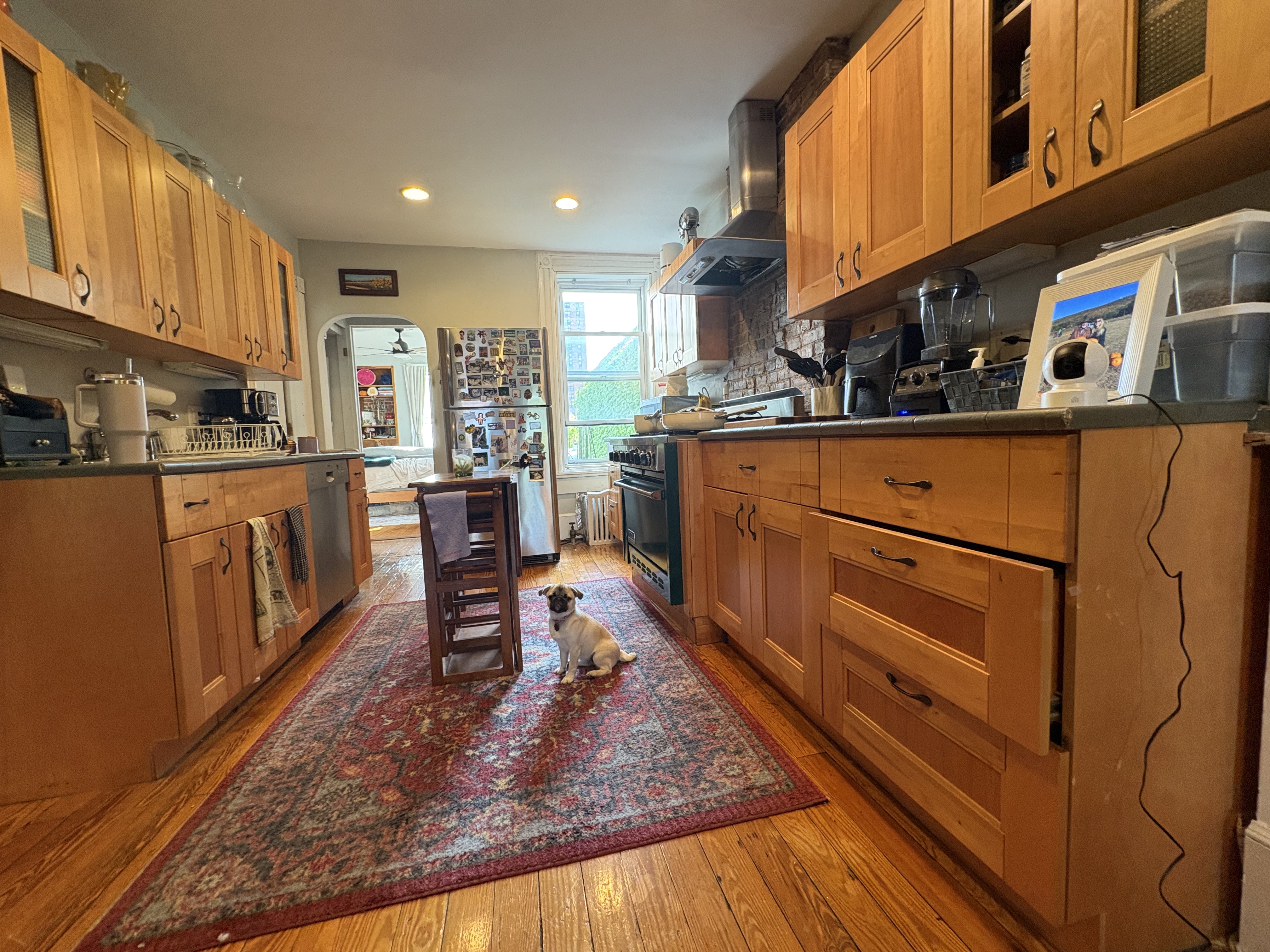 304 7th Avenue, Unit 3 Brooklyn, NY 11215 - Photo 11 of 15 a kitchen with stainless steel appliances granite countertop a refrigerator a stove and a cabinets with wooden floor