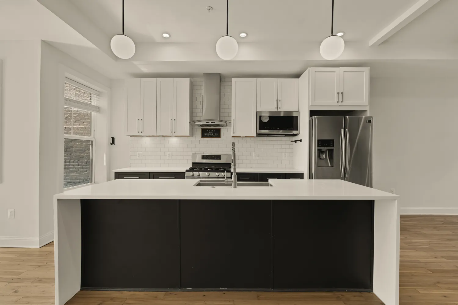 a kitchen with stainless steel appliances a stove refrigerator and cabinets