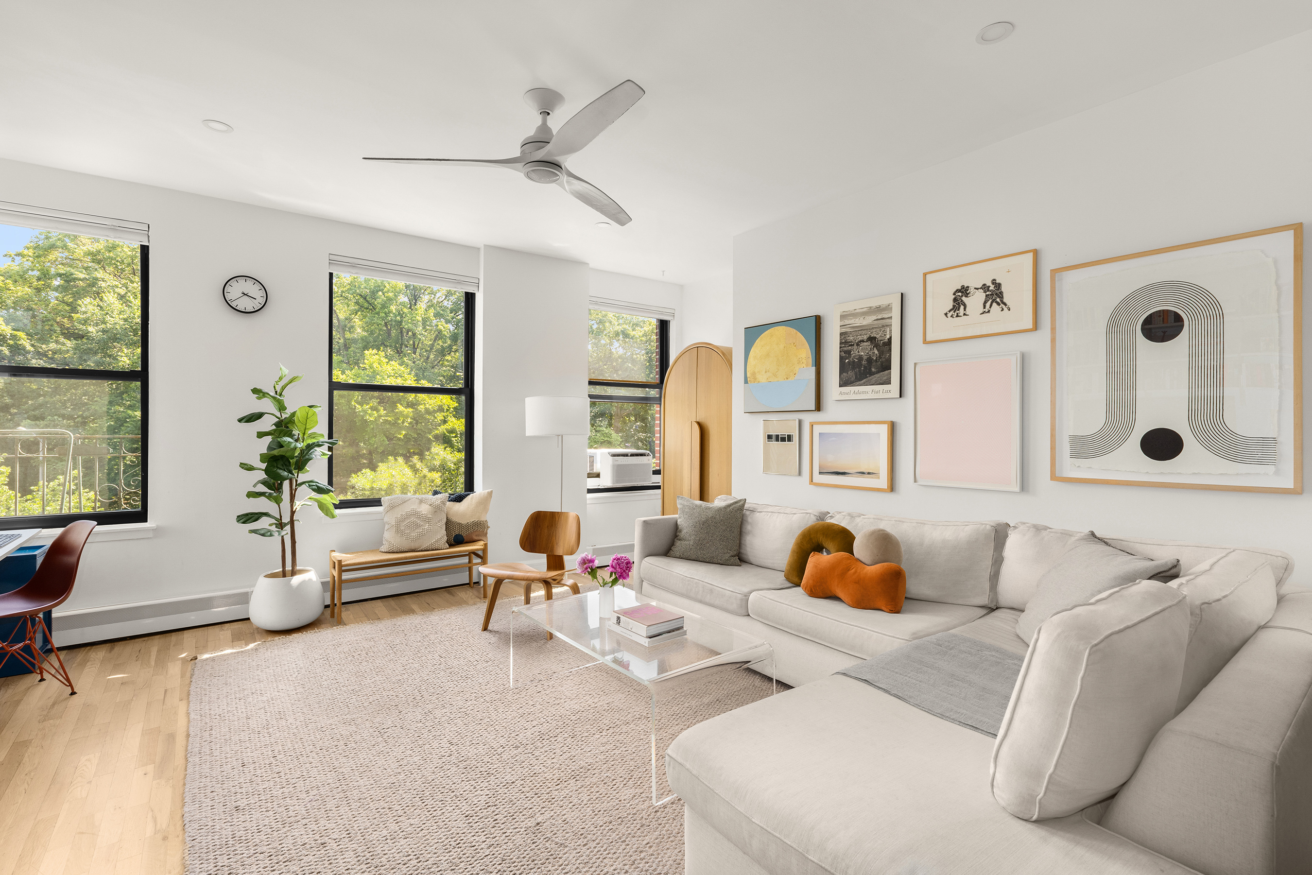 a living room with furniture ceiling fan and a window