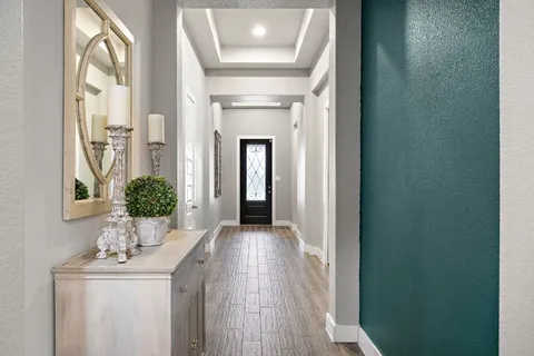 a view of a hallway to a livingroom and furniture