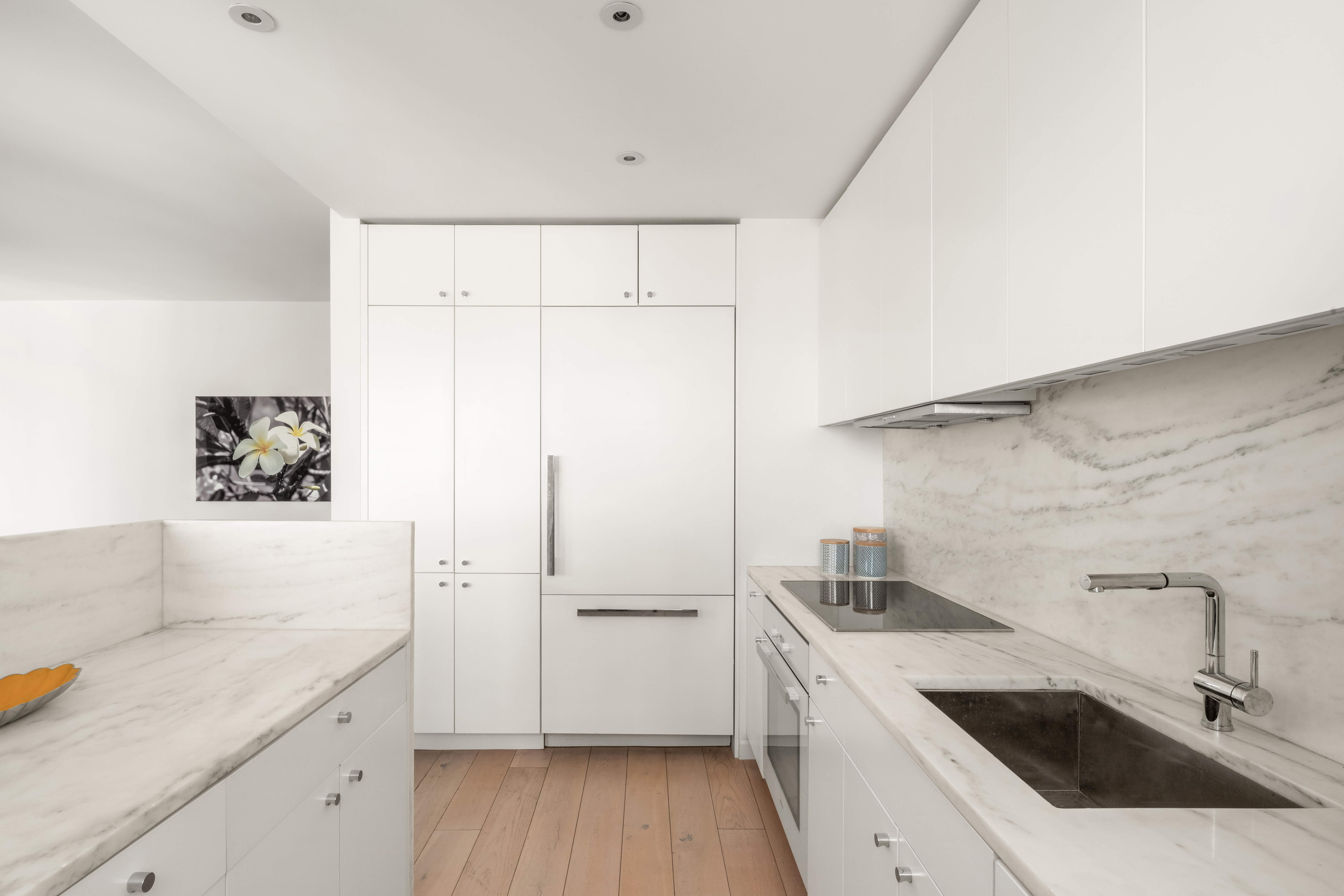 200 East 62nd Street, Unit 27A Manhattan, NY 10065 - Photo 6 of 19 a view of a kitchen with a sink and wooden floor