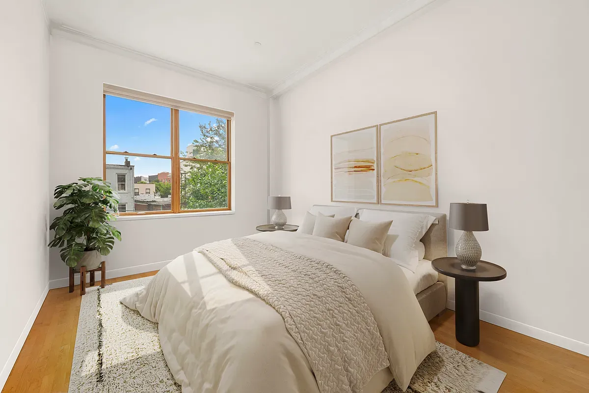 a bed sitting in a bedroom next to a window