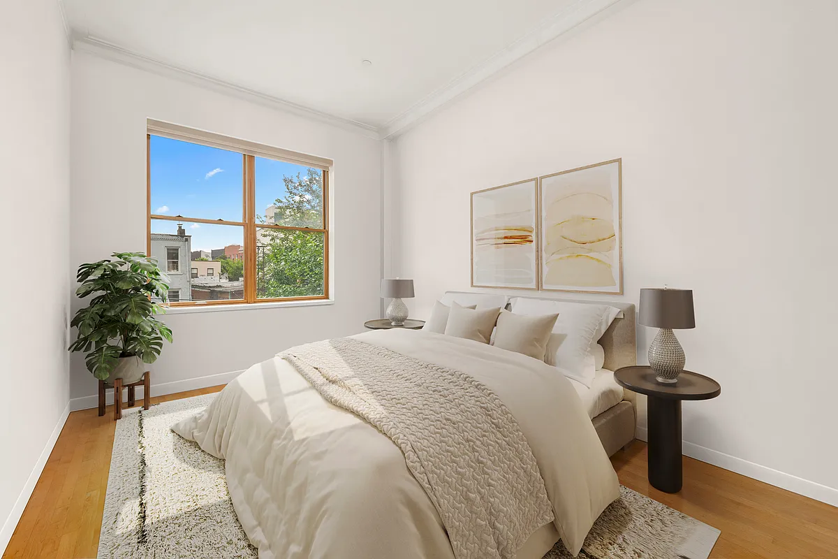 206 Kent Street, Unit 6 Brooklyn, NY 11222 - Photo 6 of 9 a bed sitting in a bedroom next to a window