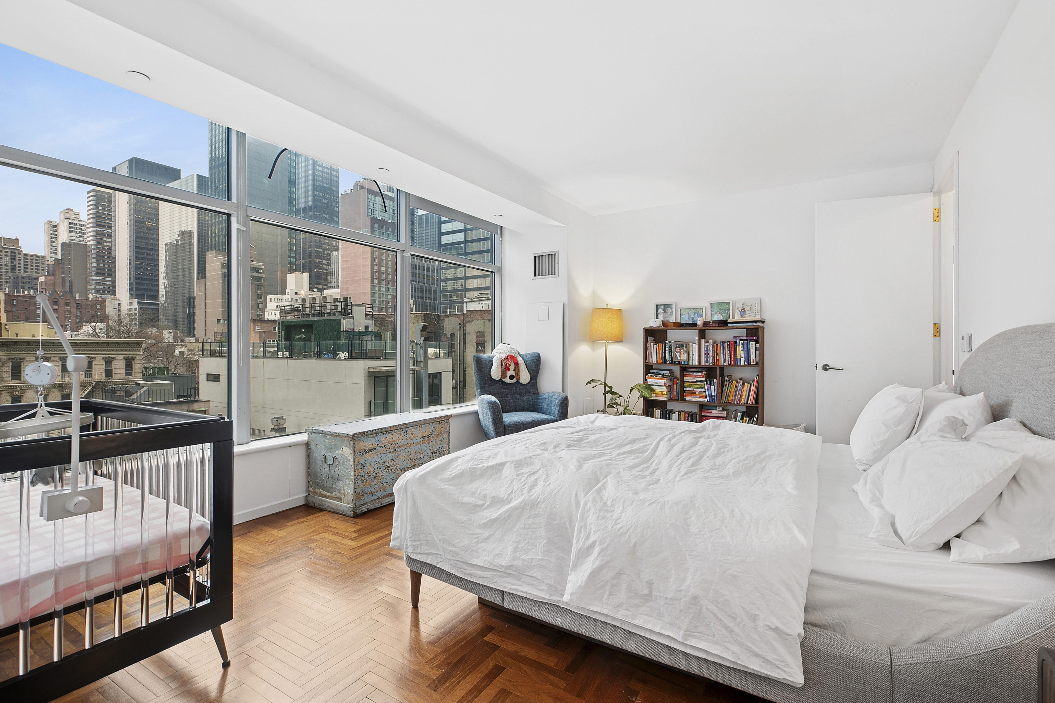 250 East 54th Street, Unit 6A Manhattan, NY 10022 - Photo 3 of 13 a living room with furniture a rug and a large window