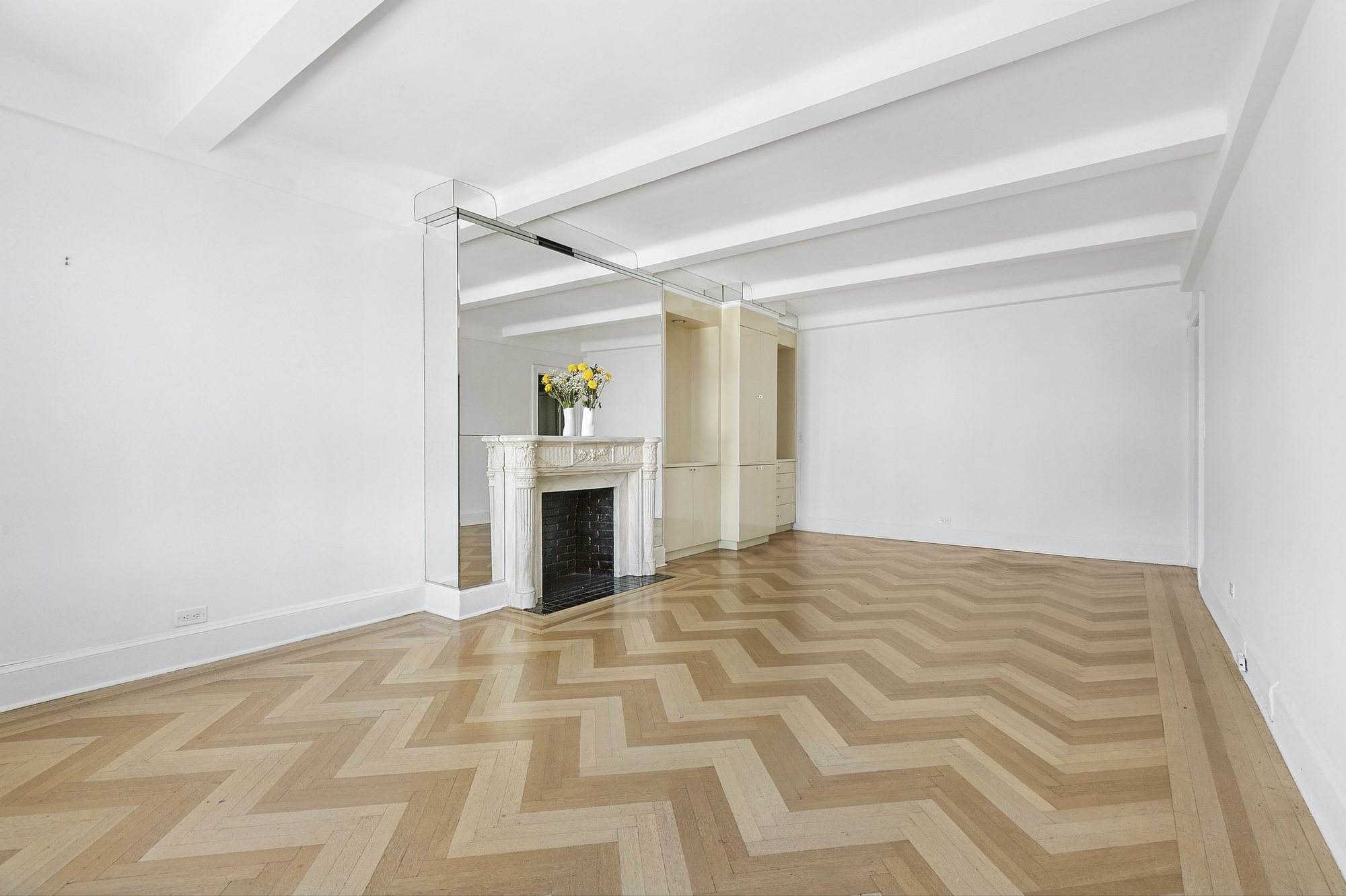 575 Park Avenue, Unit 1403 Manhattan, NY 10065 - Photo 4 of 15 a view of empty room with a fireplace