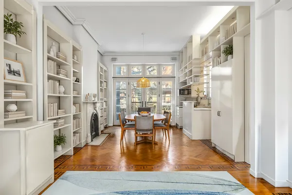 a dining room with furniture water view and large windows