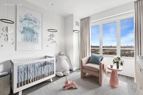 a bedroom with furniture and a large window