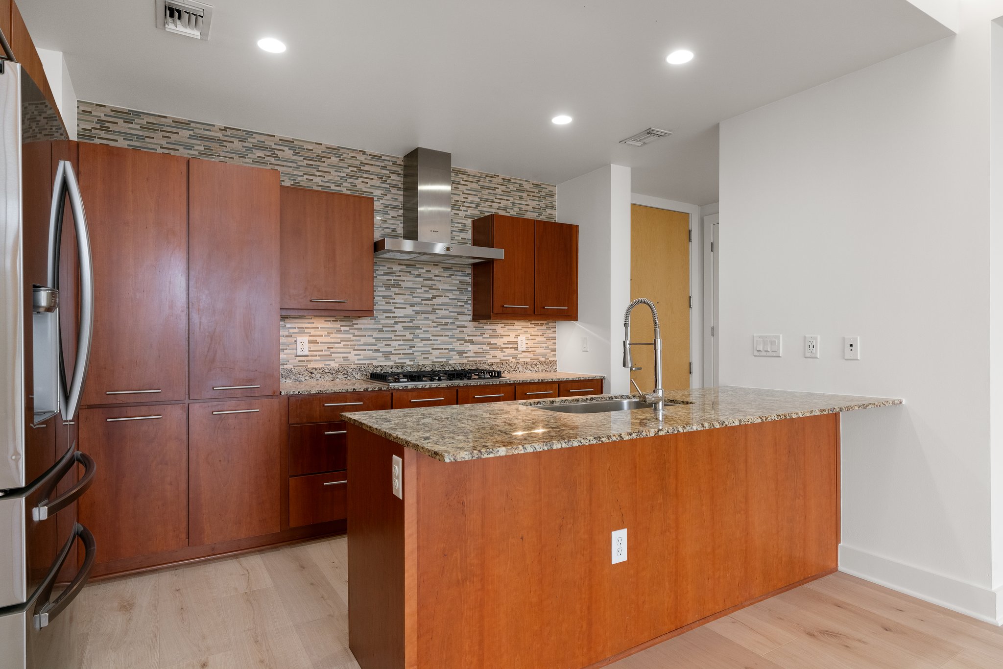 210 Lee Barton Drive, Unit 517 Austin, TX 78704 - Photo 12 of 32 a kitchen with stainless steel appliances granite countertop a refrigerator a sink and a stove