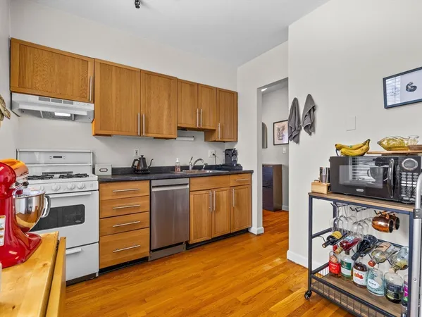 a kitchen with stainless steel appliances a stove a sink and a refrigerator