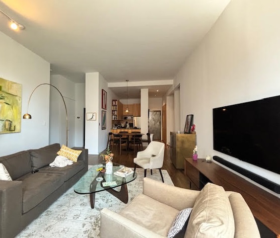 250 Mercer Street, Unit D603 Manhattan, NY 10012 - Photo 17 of 20 a living room with furniture and a flat screen tv