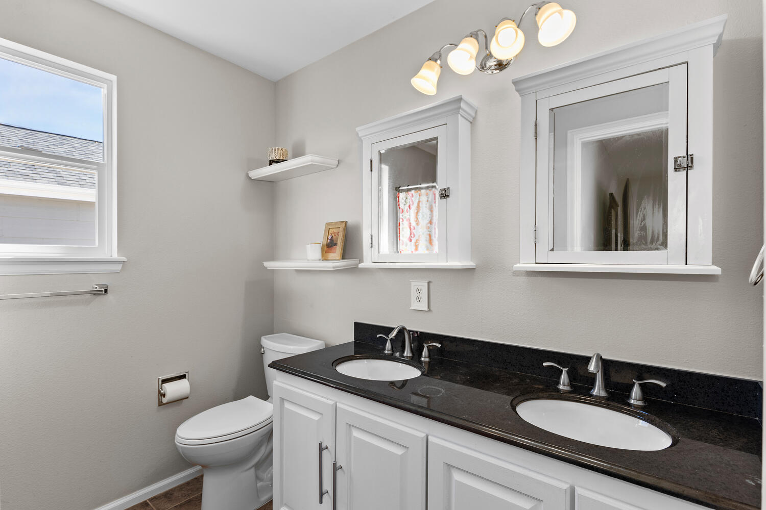 847 Timbervale Trail Highlands Ranch, CO 80129 - Photo 22 of 36 a bathroom with a granite countertop sink a toilet and mirror