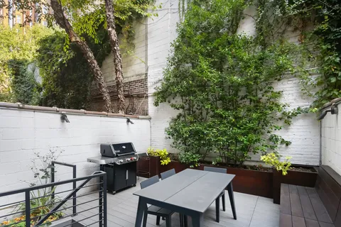 a backyard of a house with table and chairs