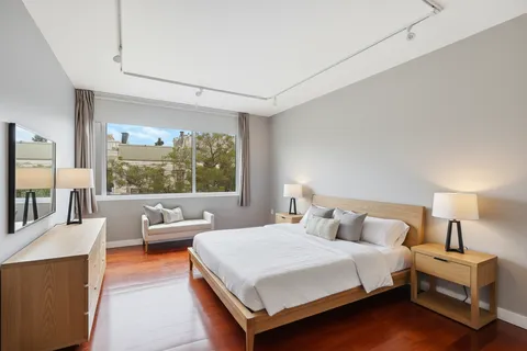 a bedroom with a large bed and a large window