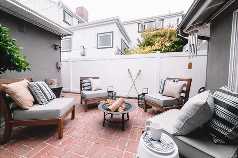 a view of a patio with couches and a table and potted plants