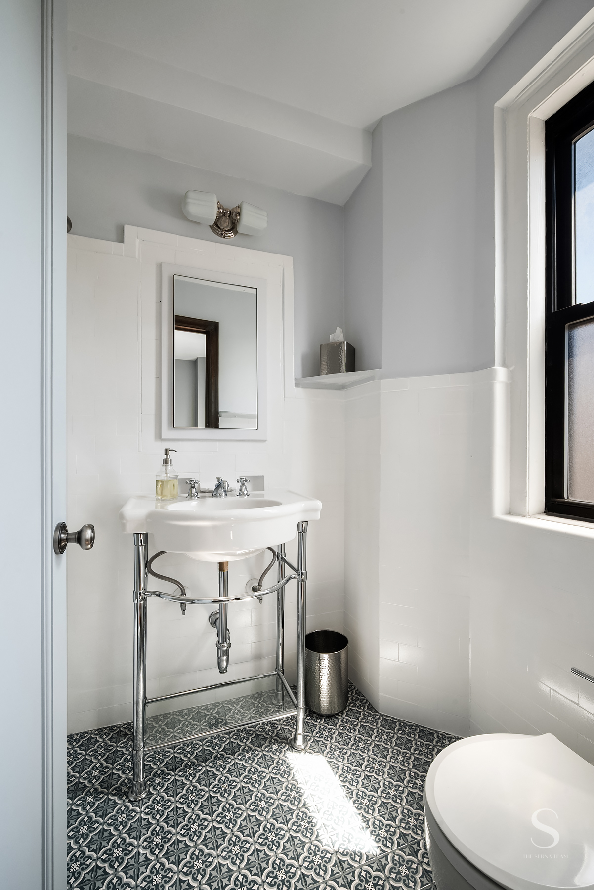 457 West 57th Street, Unit 1102 Manhattan, NY 10019 - Photo 7 of 11 a bathroom with a sink a toilet a mirror and shower