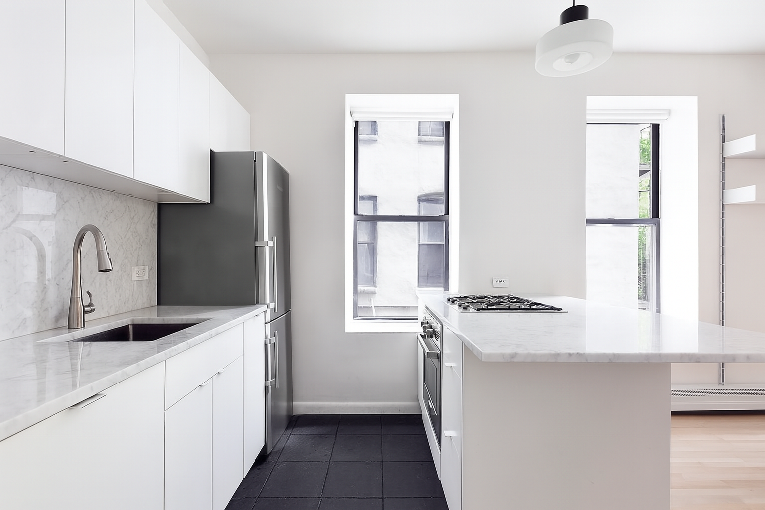 99 Avenue B, Unit 1B Manhattan, NY 10009 - Photo 4 of 8 a kitchen with stainless steel appliances granite countertop a refrigerator a stove and a sink with wooden floor