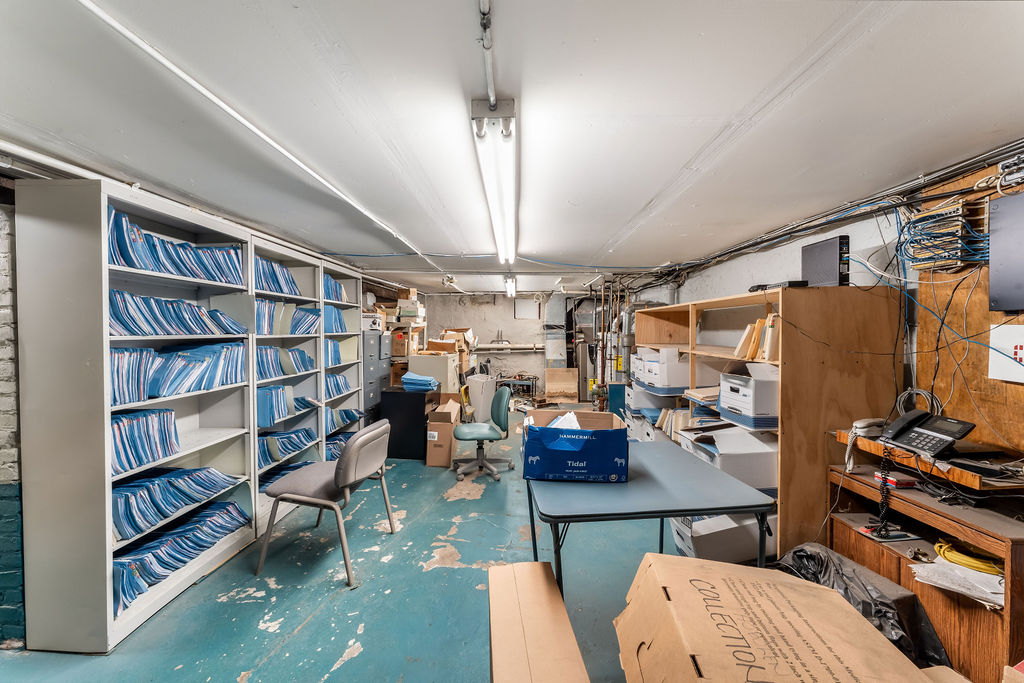 869 Bergen Avenue, Unit COMMERCIAL Jersey City, NJ 07306 - Photo 19 of 26 a view of a workspace with furniture and a bookshelf