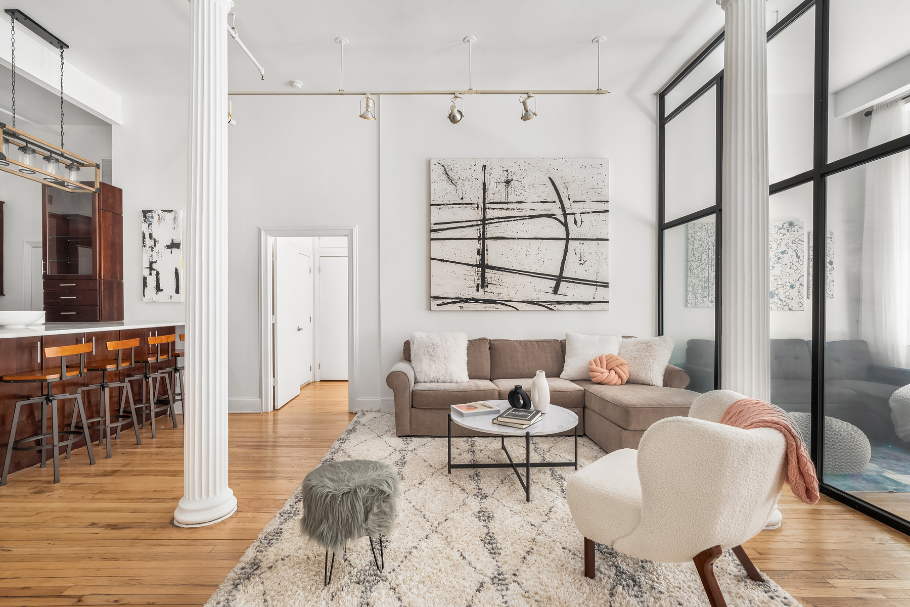 80 Leonard Street, Unit 3G Manhattan, NY 10013 - Photo 7 of 30 a living room with furniture wooden floor and a table