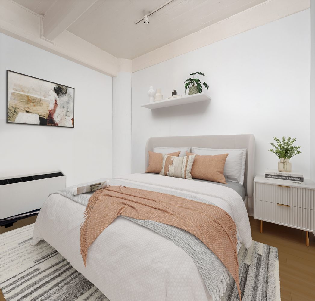 a bedroom with a bed and painting on the wall