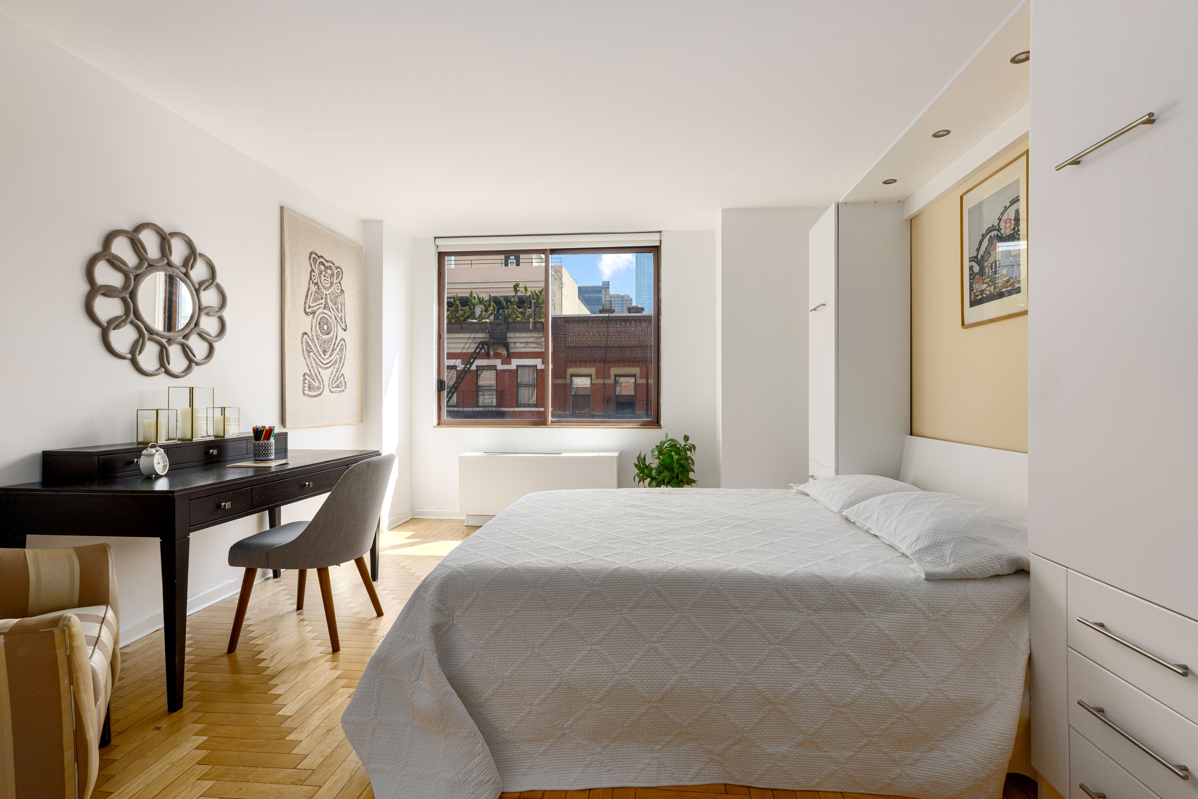 393 West 49th Street, Unit 5C Manhattan, NY 10019 - Photo 13 of 21 a living room with furniture and wooden floor