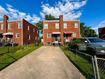 a front view of a house with yard and green space