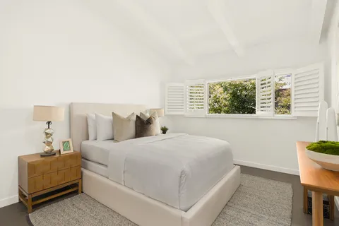 a bedroom with a large bed and a couch
